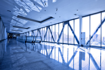 Glass corridor with escalator