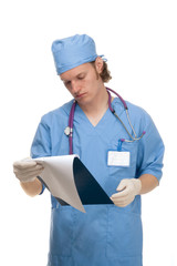 young doctor looking at clipboard