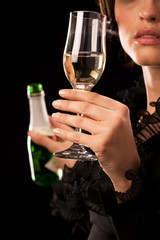 Woman poured a glass of sparkling wine