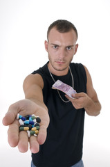 Caucasian serious man with pills and money focus on pill