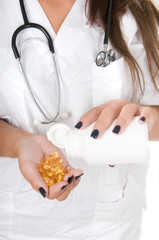doctor with pills in her hands isolated