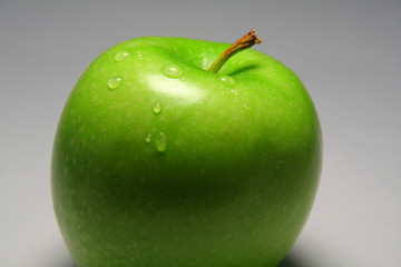 Green apple with waterdrops