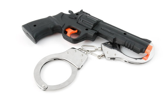 toy play gun with handcuffs over white background