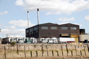 Fototapeta na wymiar Heavy goods trucks parked at a factory loading bay