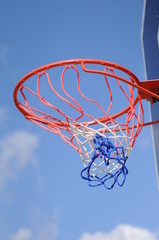 Basketball ring and net in a blue sky background