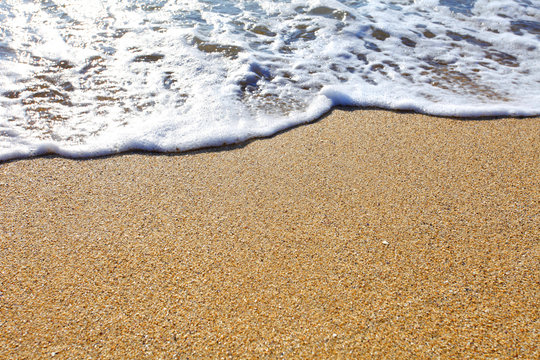 Wave and beach sand