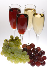champagne glasses with grapes on grey