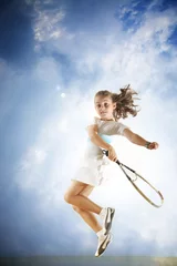 Fototapeten Young girl playing tennis over blue sky © logoboom