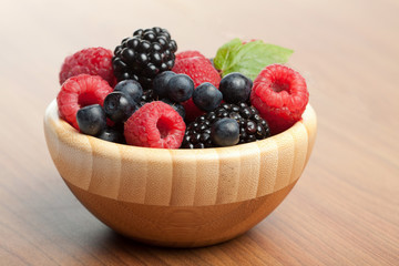 fresh berries in wood bowl