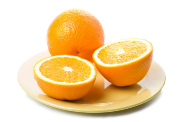 ripe oranges in yellow plate isolated