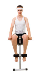 Fototapeta na wymiar Young man do fitness, sitting on bench for abdomen muscles