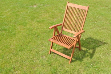 wooden chair in a green lawn