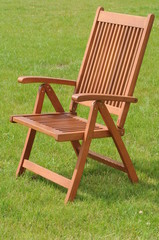 wooden chair in a green lawn