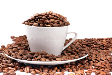White cup filled with coffee beans
