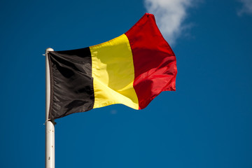 Belgian flag against blue sky