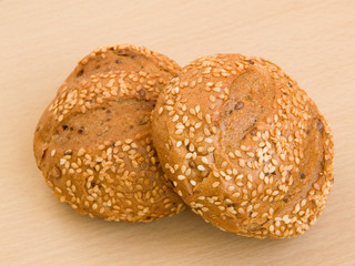 Sesame buns on the wooden background. Shallow DOF.