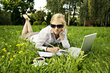 young blonde woman working outside on computer #3