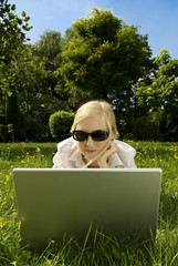 young blonde woman working outside on computer #4