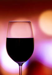 Red wine glass on a bright background
