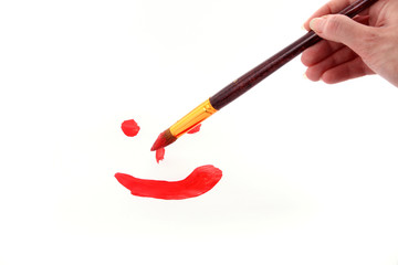 brush paints smile on paper