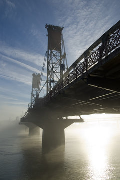 Hawthorne Bridge in Portland with fog and sun.