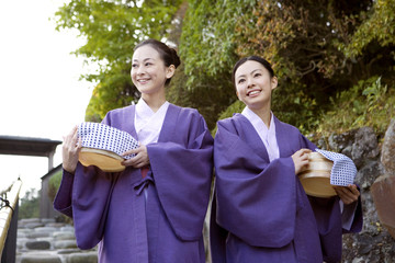 桶を持って歩く浴衣女性2人