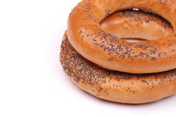 Two big bagels with a poppy