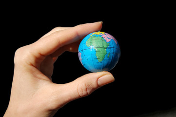Earth in hand isolated on black background