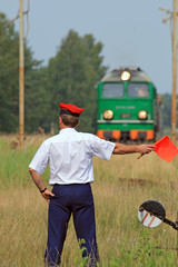 Railway traffic controller giving a signals to the train crew