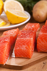 three salmon pieces on a chopping board