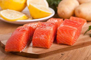 three salmon pieces on a chopping board