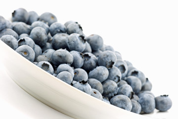 Fresh blueberries arranged on a white plate