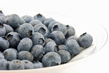 Fresh blueberries arranged on a white plate