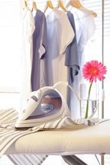 Iron on ironing board in laundry room