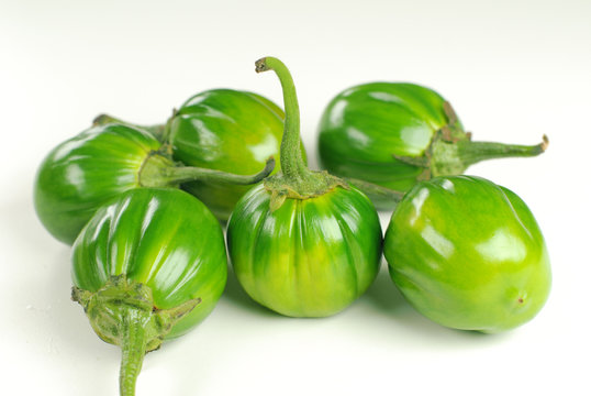 Scarlet eggplant (jiló) full screen, top view. Formerly Solanum gilo, now  considered a group of cultivars of Solanum aethiopicum, is the fruit of the  herbaceous plant Jiloeiro. Cultivated in Brazil. Stock Photo