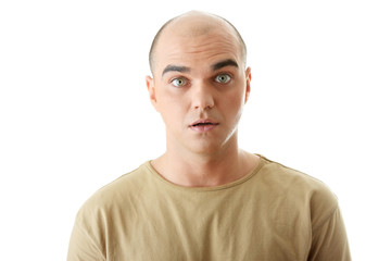 Shocked young man looking straight on a white background.