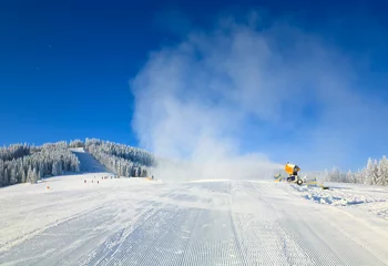 Fotobehang Snowmaking on a mountain ski resort © wildman