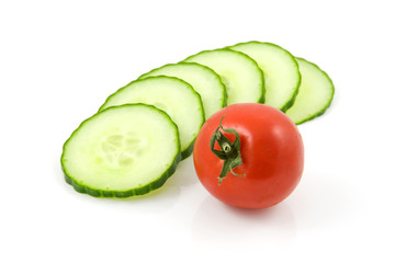 fresh cucumber in slices with tomato over white background