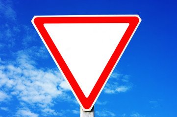 Triangle traffic sign on the blue sky background