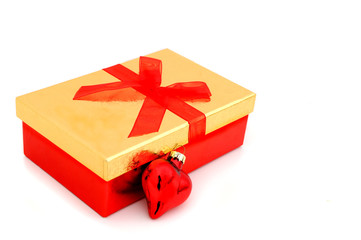 golden christmas present with red heart