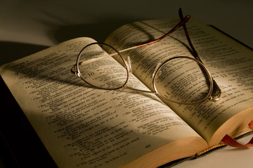 Christian Bible With Reading Glasses