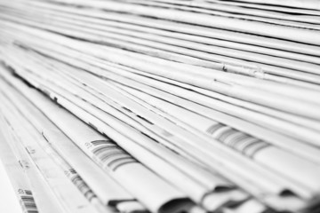 Stack of isolated newspapers in black and white