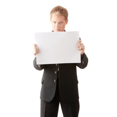 Young businessman holds blank signs.