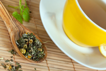 cup of green tea with herbs and candy