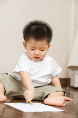 Asian toddler busy drawing