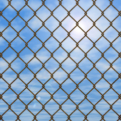 Naklejka premium フェンスの向こうの青空