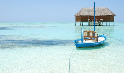 Fototapeta na wymiar Honeymoon villa in Maldives and typical boat