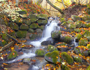 beautiful cascade waterfall in autumn forest