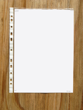 Blank paper in a plastic sleve stapled to a wood board.