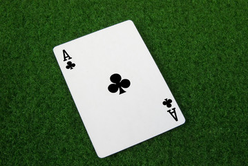 ace of clubs on green table